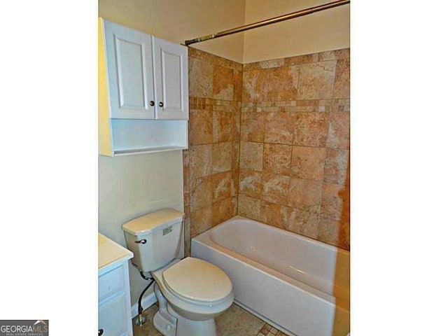 bathroom featuring toilet, vanity, and shower / tub combination