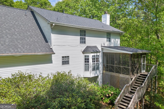 1886 Bend N Hickory Rd, Toccoa, GA 30577 - rear view of property featuring a sunroom, a shingled roof, a chimney, and stairs