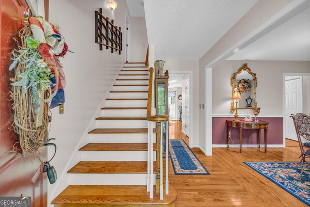 1886 Bend N Hickory Rd, Toccoa, GA 30577 - stairway featuring wood finished floors, baseboards, and a textured ceiling