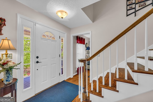 1886 Bend N Hickory Rd, Toccoa, GA 30577 - entrance foyer featuring stairway, a textured ceiling, and wood finished floors