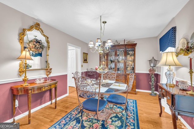 1886 Bend N Hickory Rd, Toccoa, GA 30577 - dining space featuring a chandelier, wood finished floors, and baseboards