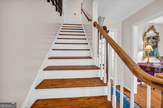 1886 Bend N Hickory Rd, Toccoa, GA 30577 - stairs featuring wood finished floors and a textured ceiling