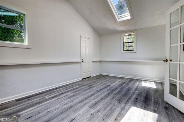 3959 Wood Path Dr, Stone Mountain, GA 30083 - unfurnished room featuring lofted ceiling, wood finished floors, and a skylight