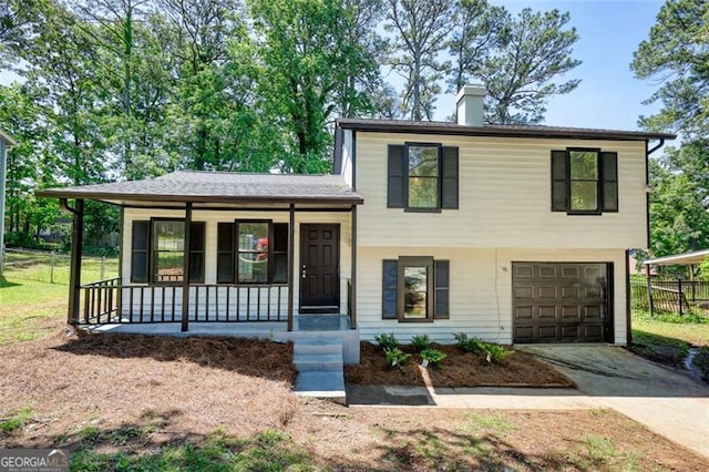 split level home featuring covered porch, concrete driveway, a chimney, an attached garage, and fence