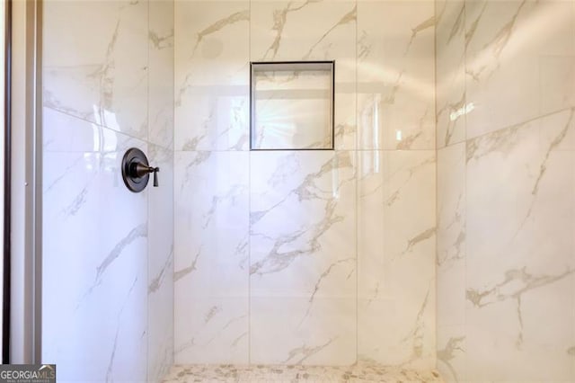 full bath featuring a marble finish shower