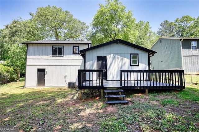 rear view of property with a wooden deck and central AC unit