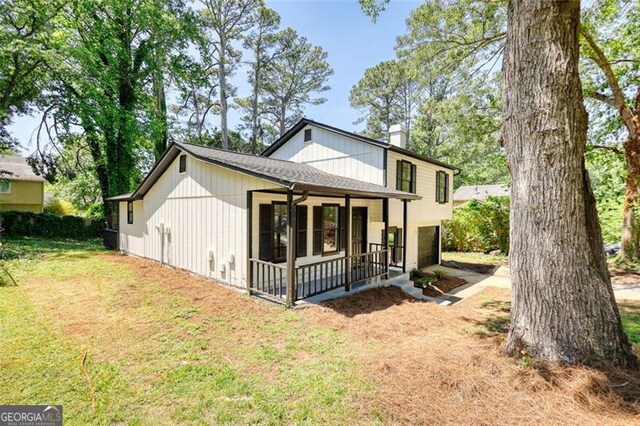 3959 Wood Path Dr, Stone Mountain, GA 30083 - view of front of house with a chimney, a front lawn, and ceiling fan