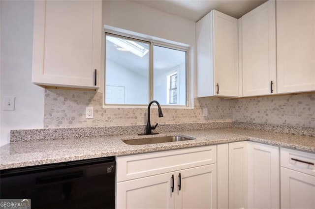 kitchen featuring dishwasher, a sink, white cabinetry, decorative backsplash, and lofted ceiling
