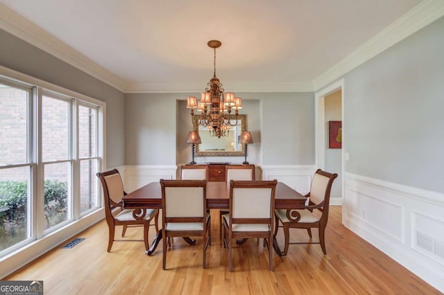 1608 Mulberry Lake Dr, Dacula, GA 30019 - dining room with a chandelier, light wood-style floors, a wainscoted wall, and ornamental molding