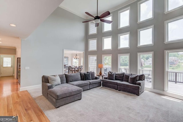 1608 Mulberry Lake Dr, Dacula, GA 30019 - living area with baseboards, crown molding, a chandelier, a towering ceiling, and ceiling fan