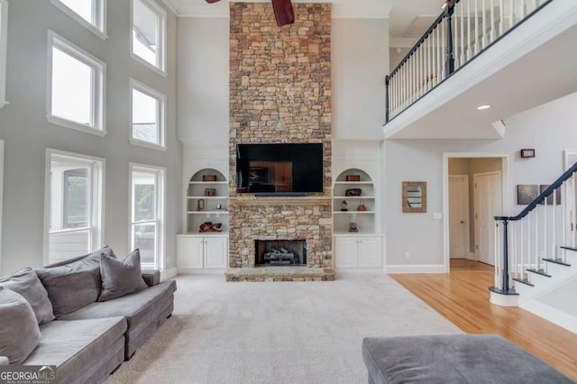 1608 Mulberry Lake Dr, Dacula, GA 30019 - living room with a high ceiling, a fireplace, stairs, built in features, and a ceiling fan