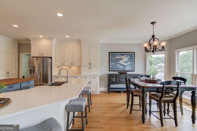 1608 Mulberry Lake Dr, Dacula, GA 30019 - dining area featuring crown molding, a chandelier, light wood-style flooring, and recessed lighting