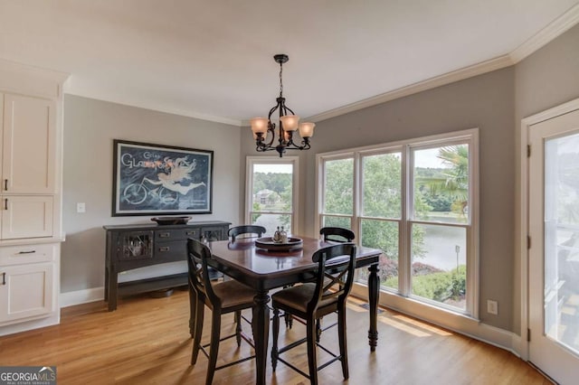 1608 Mulberry Lake Dr, Dacula, GA 30019 - dining space with a chandelier, ornamental molding, light wood-style floors, and baseboards
