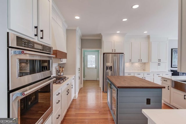 1608 Mulberry Lake Dr, Dacula, GA 30019 - kitchen with wooden counters, stainless steel appliances, crown molding, white cabinetry, and recessed lighting