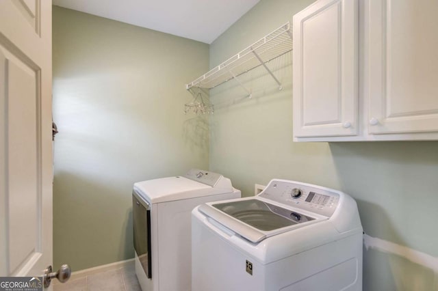 1608 Mulberry Lake Dr, Dacula, GA 30019 - laundry room featuring independent washer and dryer, baseboards, cabinet space, and tile patterned flooring