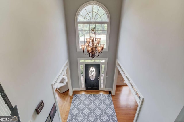 1608 Mulberry Lake Dr, Dacula, GA 30019 - foyer entrance with a chandelier, light wood finished floors, a high ceiling, and baseboards