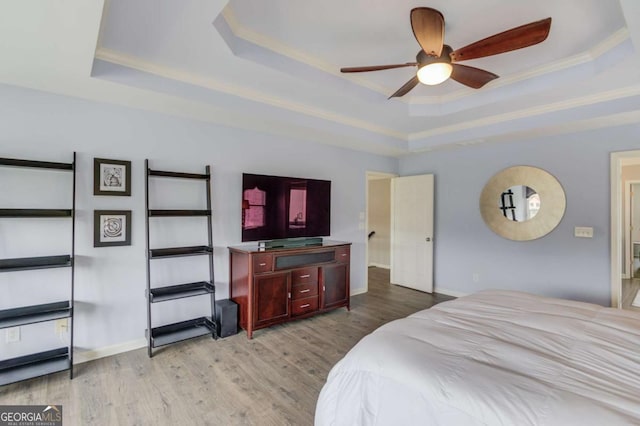 1608 Mulberry Lake Dr, Dacula, GA 30019 - bedroom featuring a tray ceiling, light wood-type flooring, ornamental molding, and baseboards