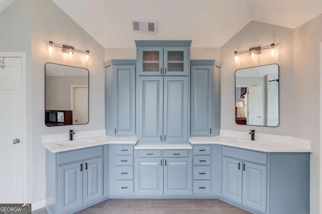 1608 Mulberry Lake Dr, Dacula, GA 30019 - bathroom featuring vaulted ceiling, double vanity, and tile patterned flooring