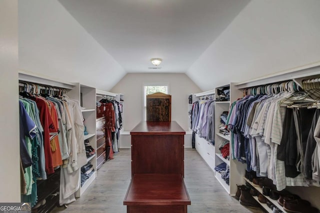 1608 Mulberry Lake Dr, Dacula, GA 30019 - walk in closet featuring lofted ceiling and wood finished floors