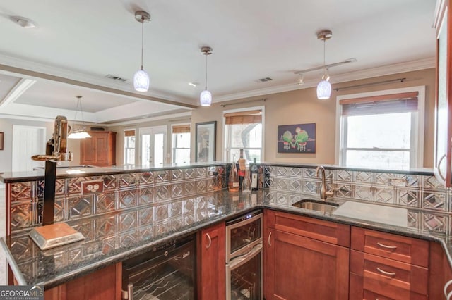 1608 Mulberry Lake Dr, Dacula, GA 30019 - kitchen with wine cooler, a sink, dark stone counters, pendant lighting, and crown molding