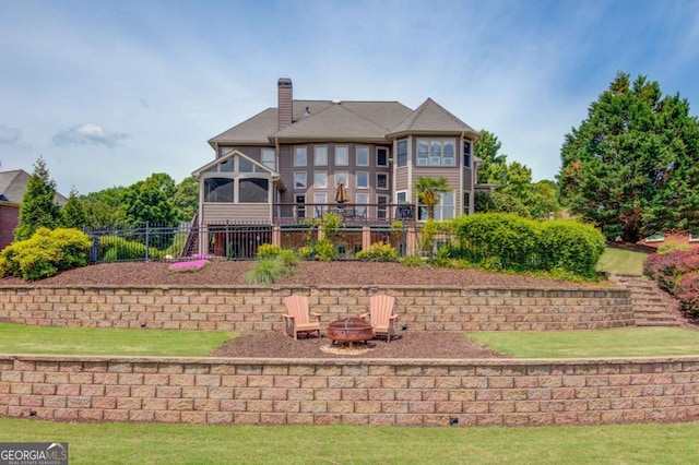 1608 Mulberry Lake Dr, Dacula, GA 30019 - rear view of property with an outdoor fire pit and a chimney