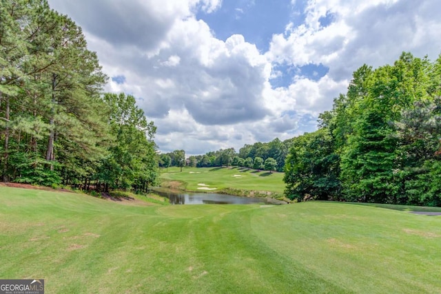 1608 Mulberry Lake Dr, Dacula, GA 30019 - view of community with golf course view, a water view, a lawn, and view of wooded area