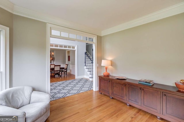 1608 Mulberry Lake Dr, Dacula, GA 30019 - living area featuring light wood-type flooring, crown molding, and stairs