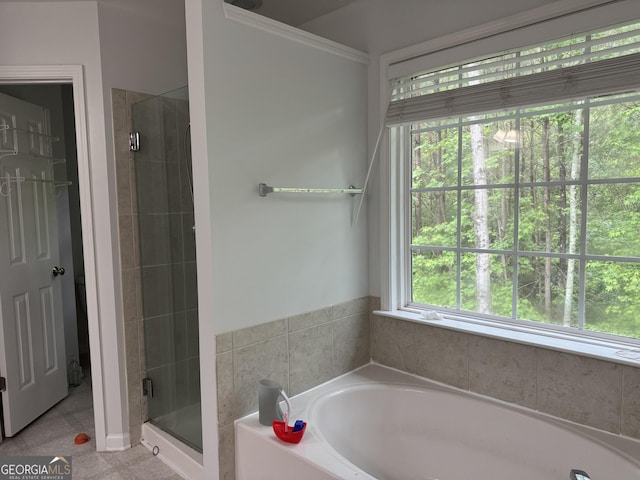 full bathroom featuring a shower stall, a bath, and crown molding