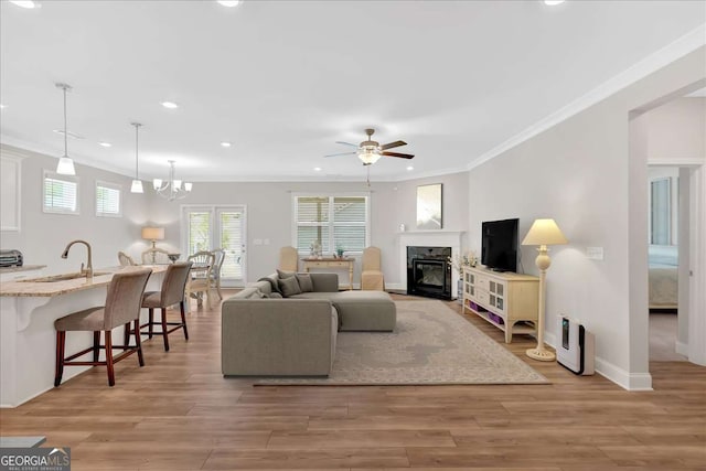 427 Bluffs View Ln, Canton, GA 30114 - living area with a ceiling fan, ornamental molding, recessed lighting, light wood-style flooring, and a glass covered fireplace