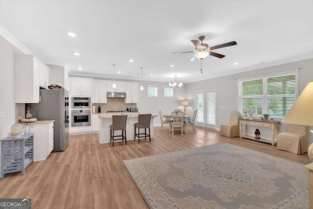 427 Bluffs View Ln, Canton, GA 30114 - living room with crown molding, a ceiling fan, light wood-style flooring, a chandelier, and recessed lighting
