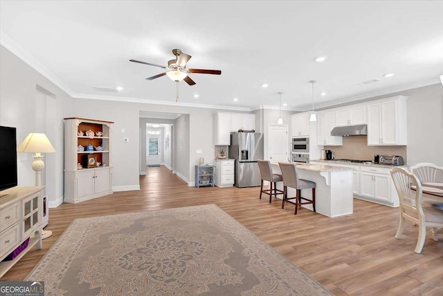 427 Bluffs View Ln, Canton, GA 30114 - kitchen featuring stainless steel appliances, a breakfast bar, a ceiling fan, under cabinet range hood, and light wood-style floors