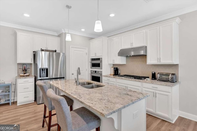 427 Bluffs View Ln, Canton, GA 30114 - kitchen featuring under cabinet range hood, appliances with stainless steel finishes, a sink, ornamental molding, and white cabinets