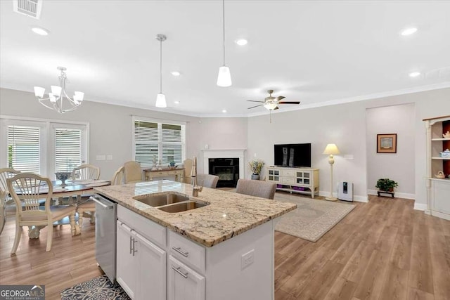 427 Bluffs View Ln, Canton, GA 30114 - kitchen with a sink, dishwasher, a glass covered fireplace, an island with sink, and a chandelier