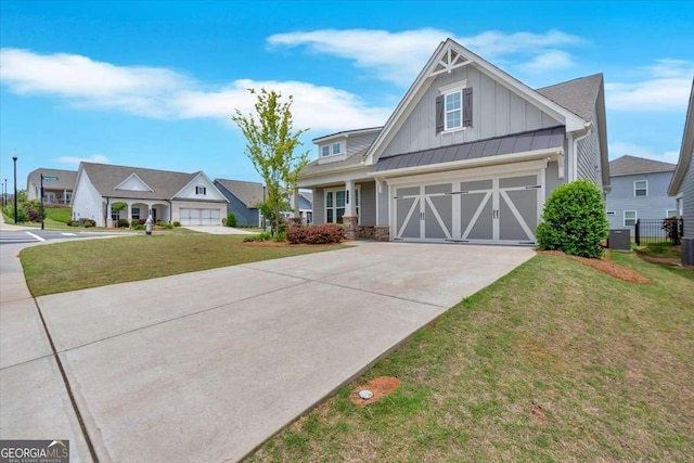 427 Bluffs View Ln, Canton, GA 30114 - view of front of home with board and batten siding, concrete driveway, a front yard, a garage, and central AC