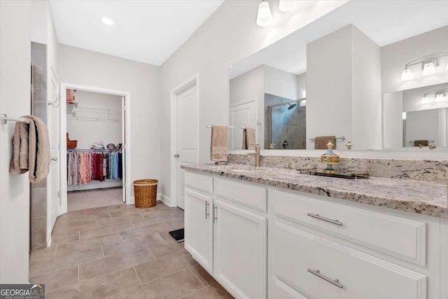 427 Bluffs View Ln, Canton, GA 30114 - bathroom featuring a shower stall, a spacious closet, vanity, and tile patterned flooring