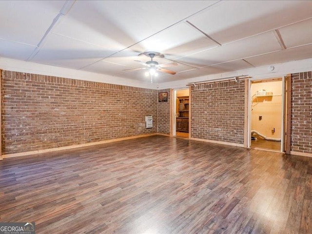 219 Briarwood Dr, Dallas, GA 30132 - unfurnished living room featuring brick wall, ceiling fan, wood finished floors, and heating unit