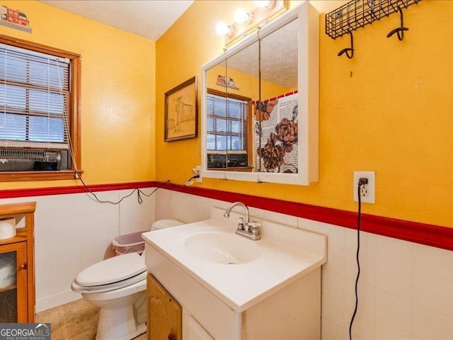 219 Briarwood Dr, Dallas, GA 30132 - bathroom featuring vanity, tile walls, a wainscoted wall, healthy amount of natural light, and tile patterned floors