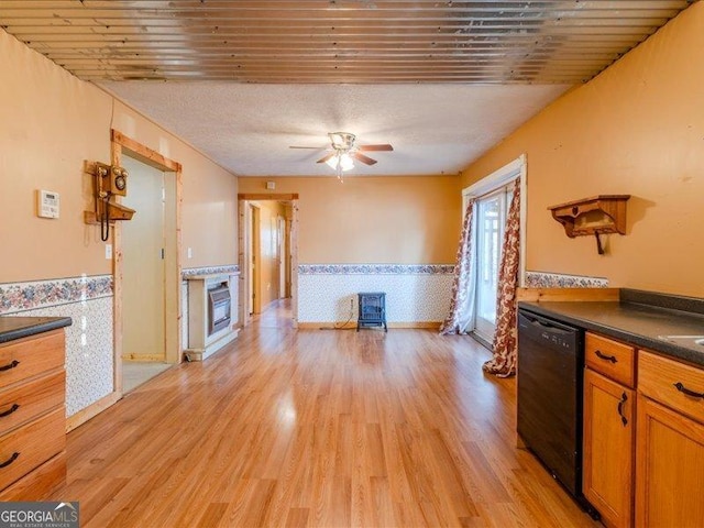 219 Briarwood Dr, Dallas, GA 30132 - kitchen featuring black dishwasher, a wainscoted wall, dark countertops, light wood finished floors, and ceiling fan