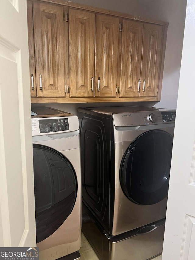 1311 N Brandy Shls, Conyers, GA 30013 - washroom with washing machine and clothes dryer and cabinet space