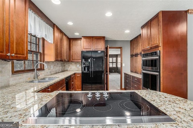 1791 Lake George Dr, Lithia Springs, GA 30122 - kitchen with black appliances, a sink, light stone counters, tasteful backsplash, and recessed lighting