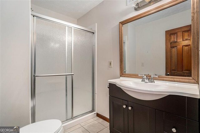 1791 Lake George Dr, Lithia Springs, GA 30122 - bathroom with a stall shower, tile patterned floors, toilet, and vanity