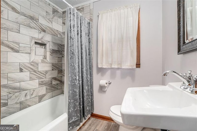 1791 Lake George Dr, Lithia Springs, GA 30122 - full bathroom with wood finished floors, a sink, toilet, baseboards, and shower / tub combo