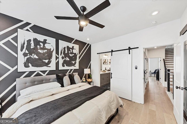 701 Pryor St SW # 5, Atlanta, GA 30315 - bedroom with a barn door, wood finished floors, recessed lighting, ensuite bath, and a ceiling fan