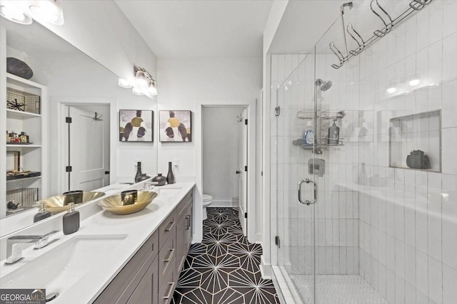 701 Pryor St SW # 5, Atlanta, GA 30315 - bathroom featuring toilet, a stall shower, double vanity, and tile patterned floors