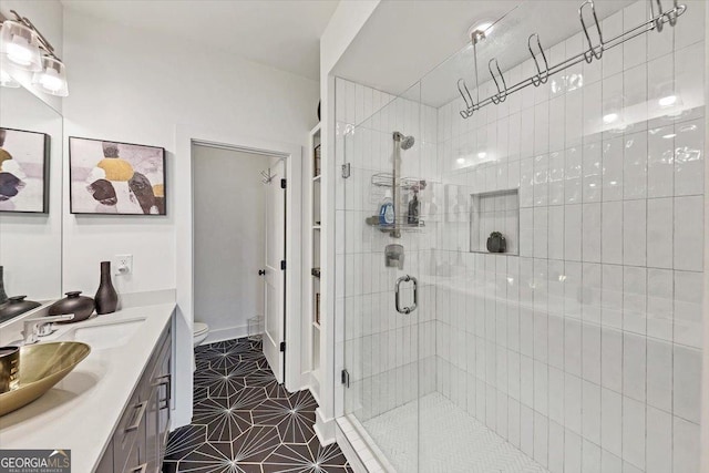 701 Pryor St SW # 5, Atlanta, GA 30315 - full bathroom featuring a stall shower, vanity, toilet, and tile patterned flooring