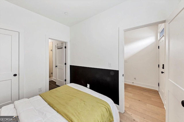 701 Pryor St SW # 5, Atlanta, GA 30315 - bedroom featuring wood finished floors, baseboards, ensuite bath, and vaulted ceiling