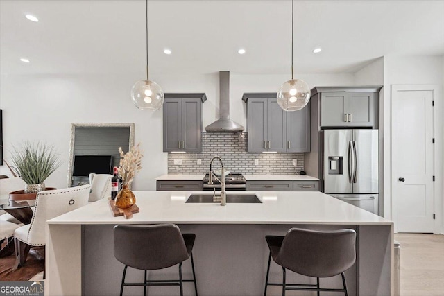 701 Pryor St SW # 5, Atlanta, GA 30315 - kitchen featuring wall chimney exhaust hood, stainless steel refrigerator with ice dispenser, gray cabinets, a sink, and light wood-style flooring