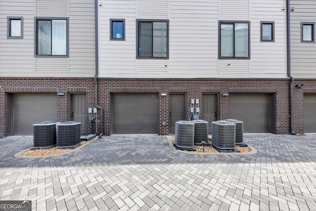 701 Pryor St SW # 5, Atlanta, GA 30315 - rear view of house with a garage, brick siding, central AC unit, and driveway