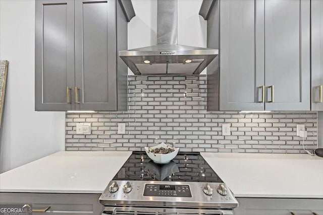 701 Pryor St SW # 5, Atlanta, GA 30315 - kitchen with island exhaust hood, gray cabinets, stainless steel range with electric cooktop, light countertops, and tasteful backsplash