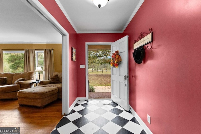 doorway to outside with baseboards, tile patterned floors, and ornamental molding